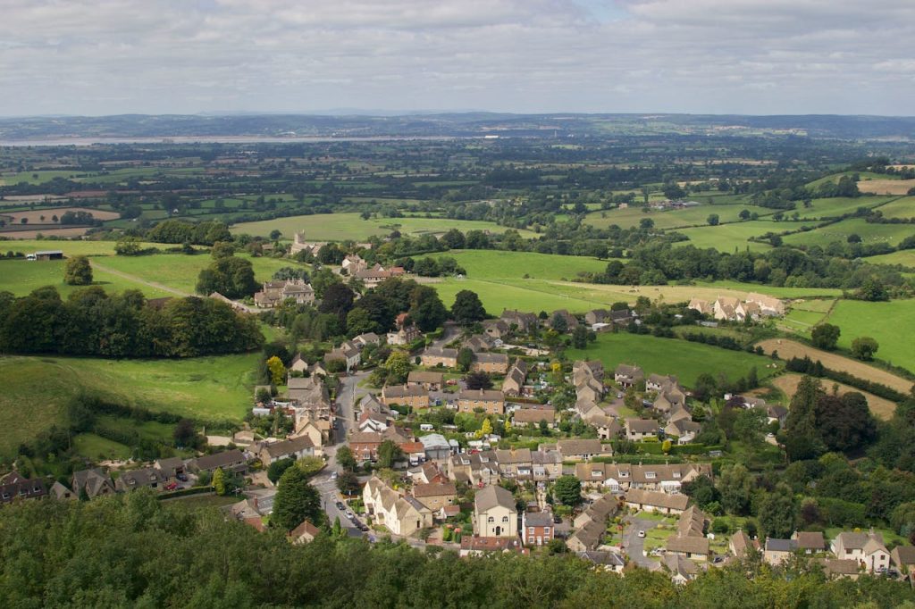Discover the picturesque landscape of Wotton-under-Edge, England, showcasing lush fields and quaint architecture.
