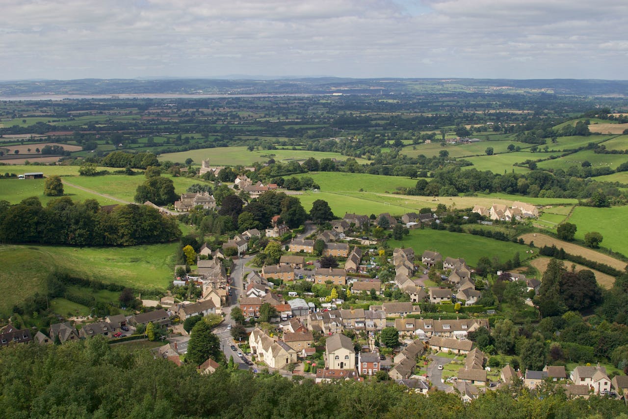 Discover the picturesque landscape of Wotton-under-Edge, England, showcasing lush fields and quaint architecture.