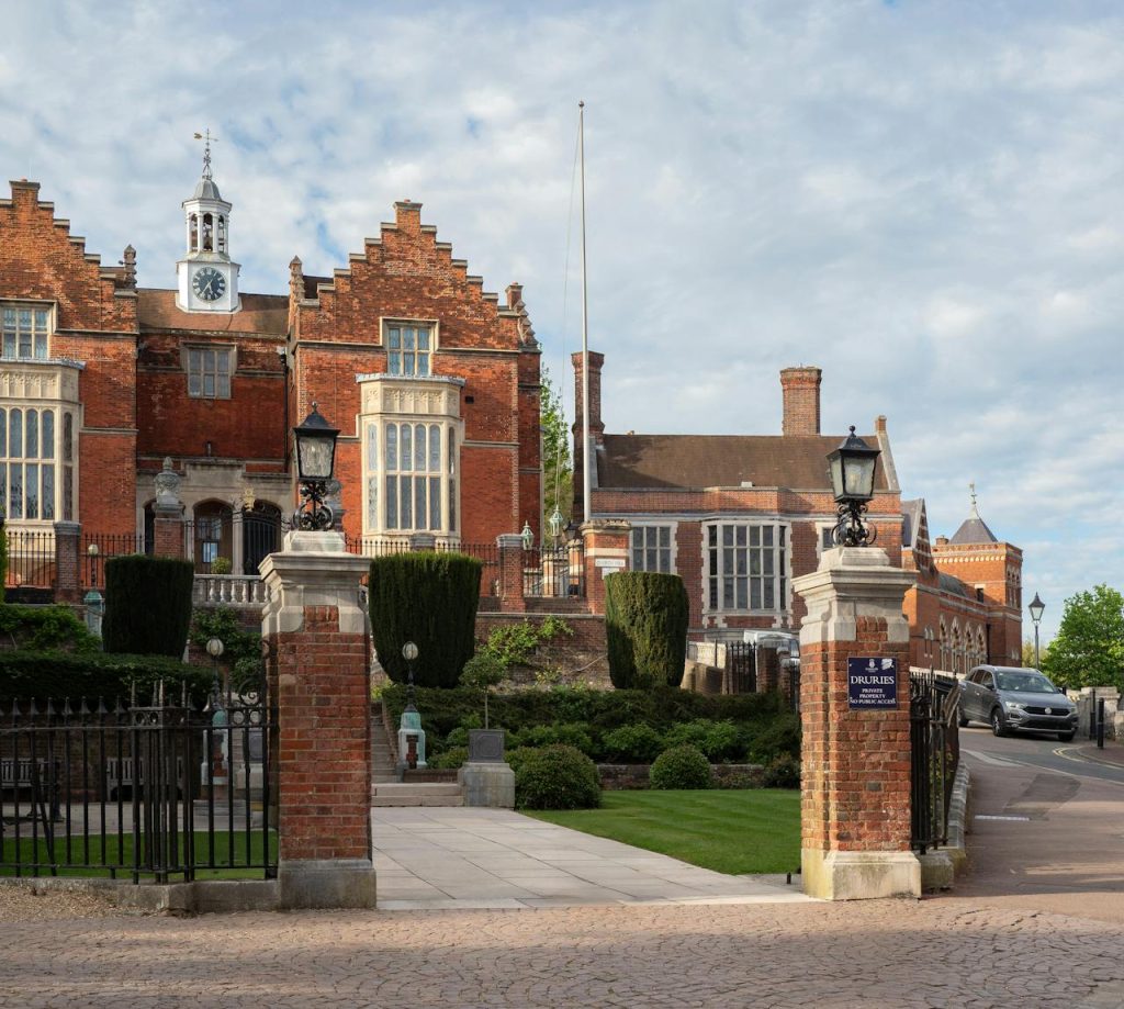 View of the grand entrance and architecture of Harrow School in London.